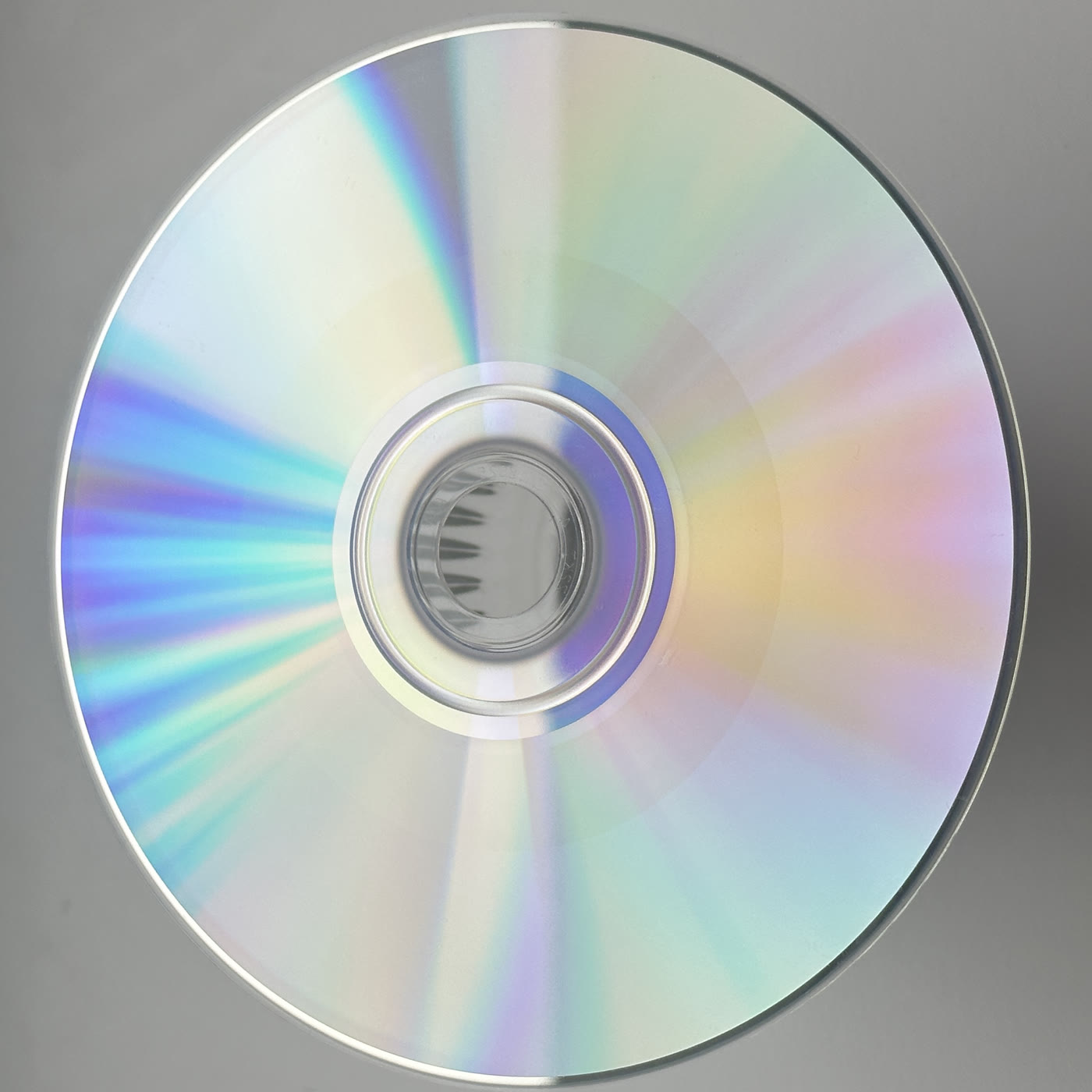 A hand-burned CD, silver side up, catching light.